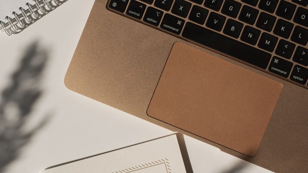 Minimalist desk with macbook and notebooks