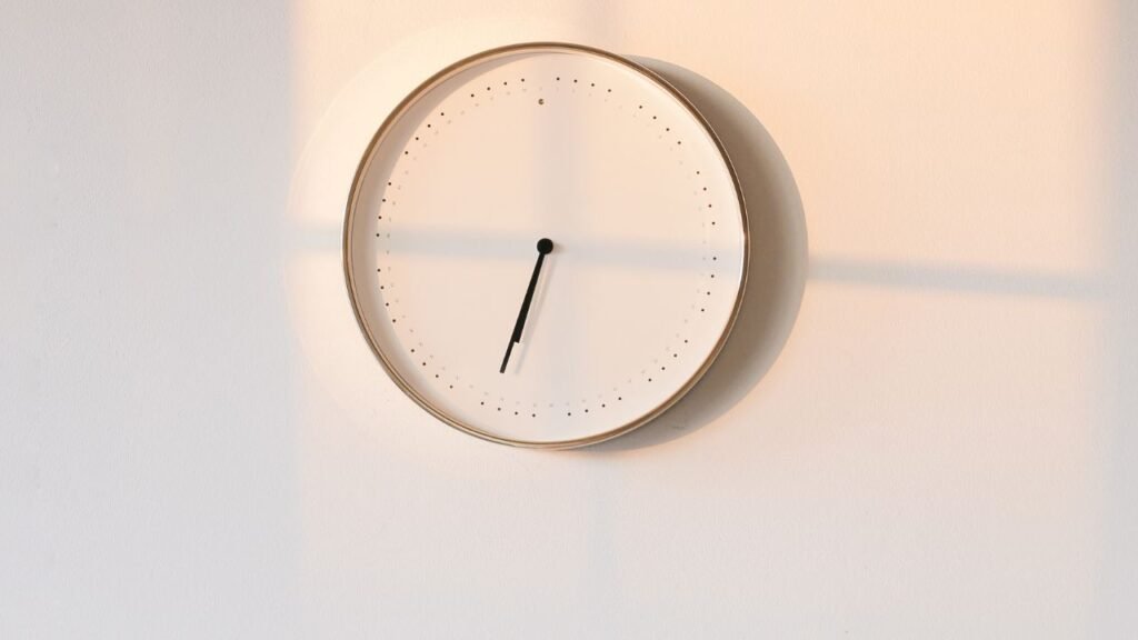 White analog clock on wall