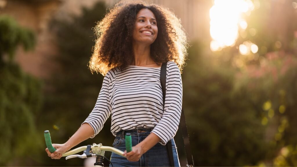 Young woman strolling with her bike