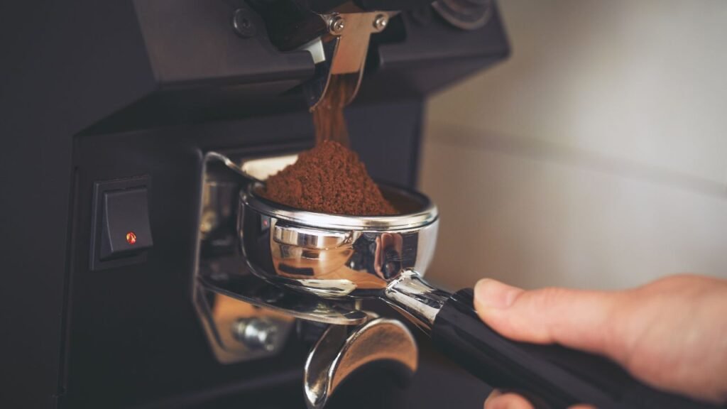 Coffee grinder grinds freshly coffee beans