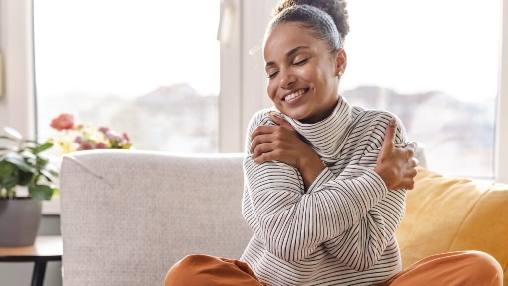 Young beautiful woman hugging herself