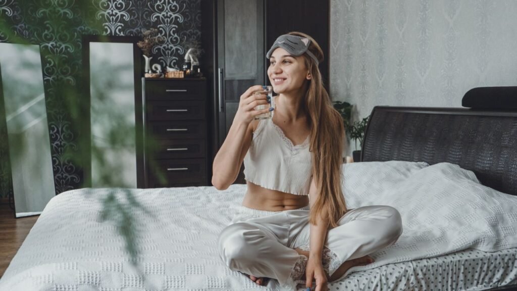 Young woman drinking water in the morning